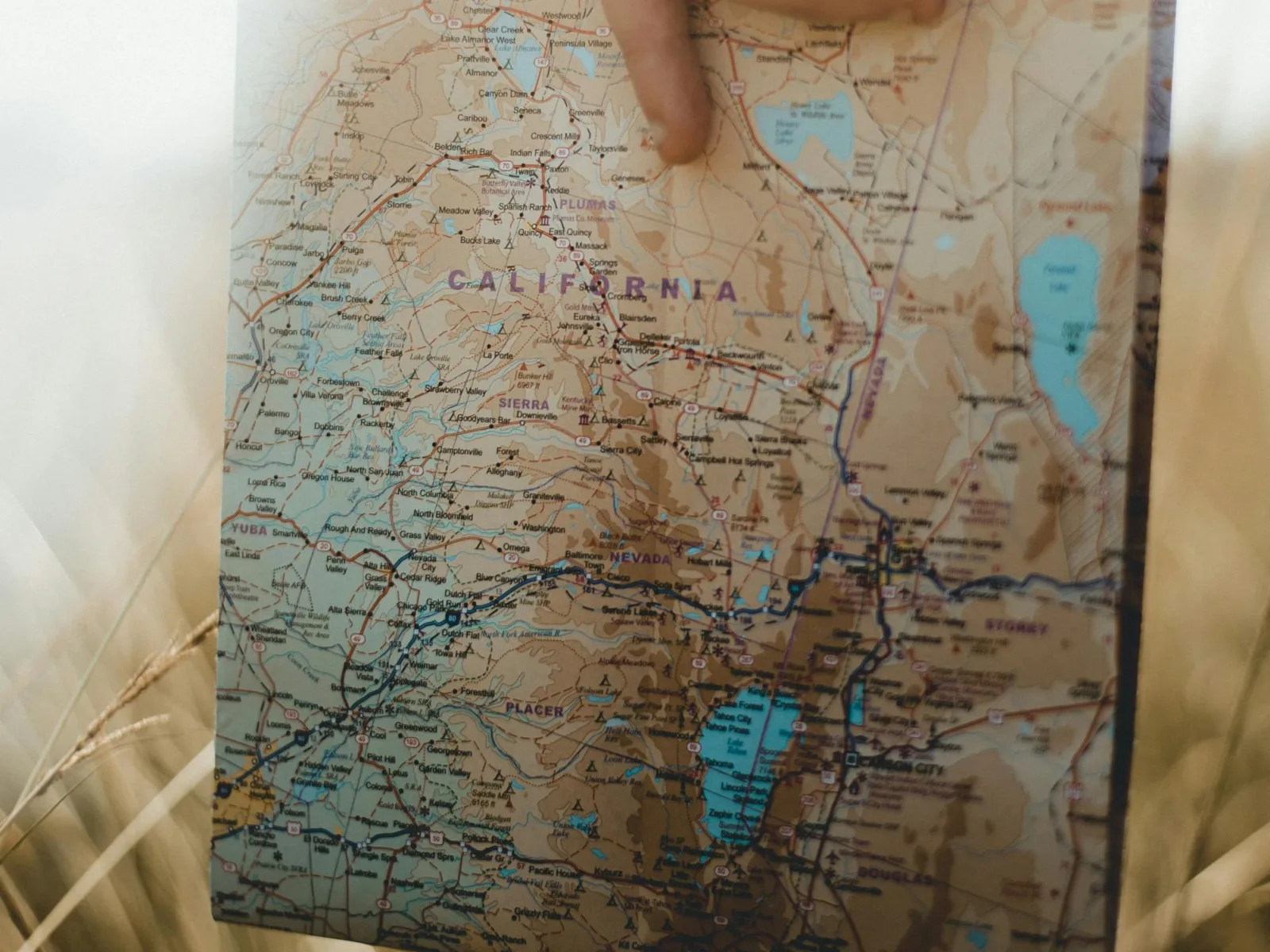 a hand holding a folded map